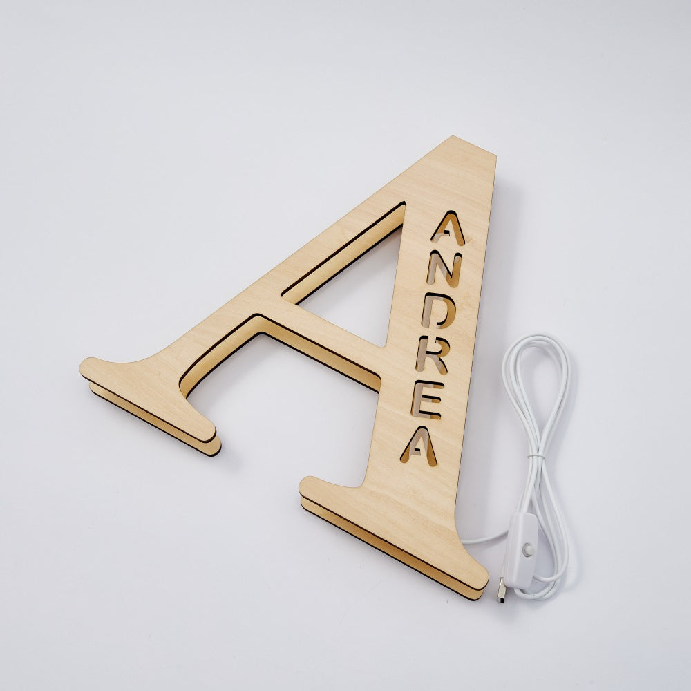 Personalized wooden night light 'A' with 'ANDREA' name, emitting warm LED glow, 28cm tall, ideal home decor.