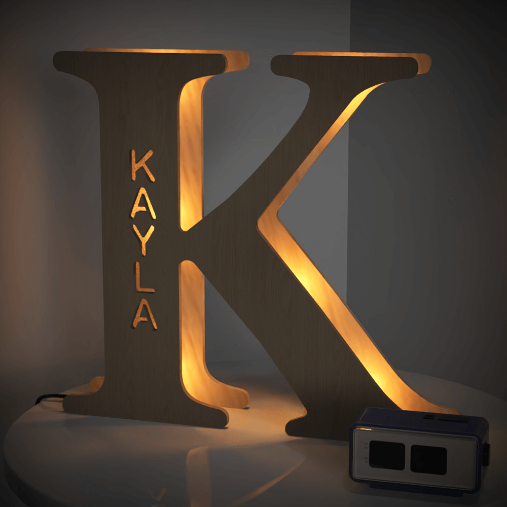 Personalized wooden 'K' night light with 'KAYLA' name, 28cm tall, warm LED glow, home decor