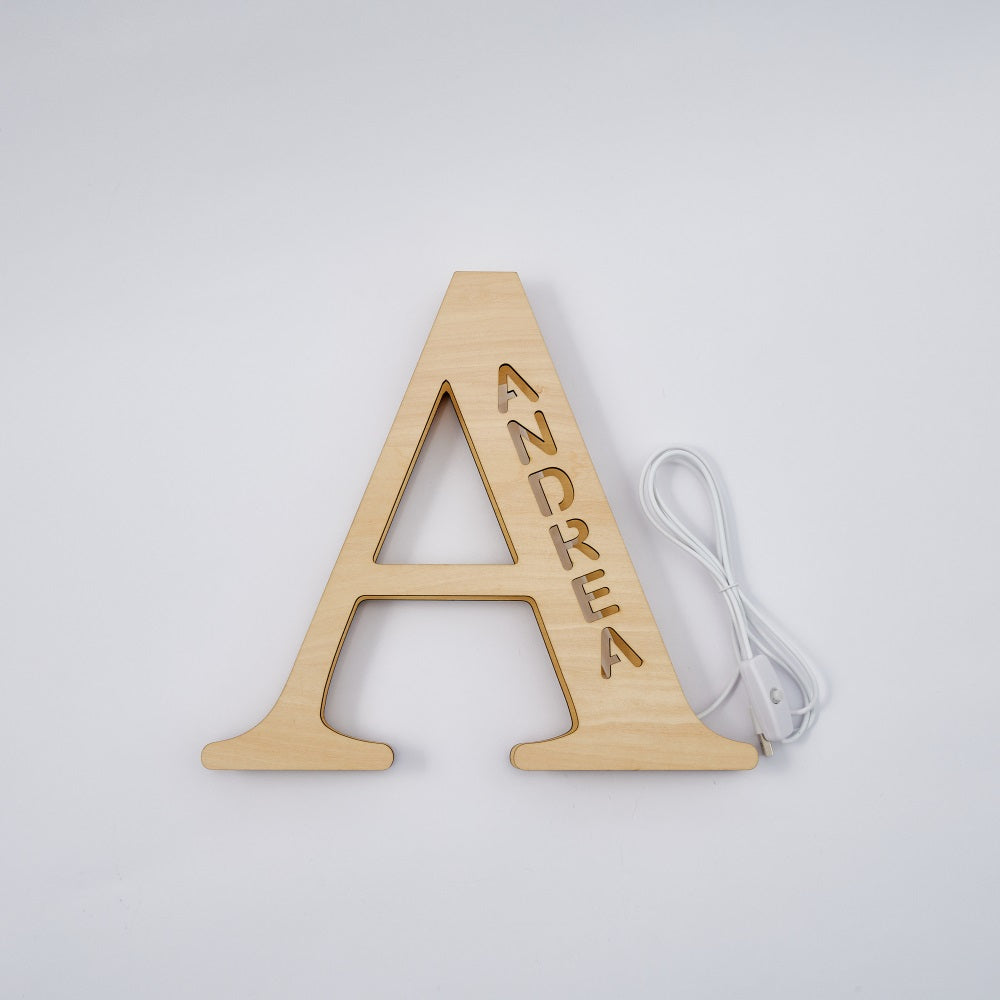 Personalized 'A' wooden night light with 'ANDREA' name, emitting warm LED glow, home decor, 28cm.